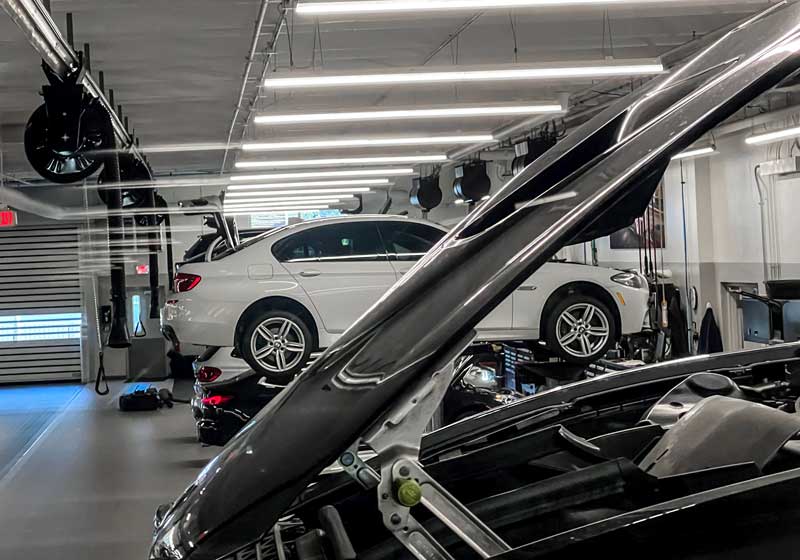 best car warranty having bmw on a lift at the dealership