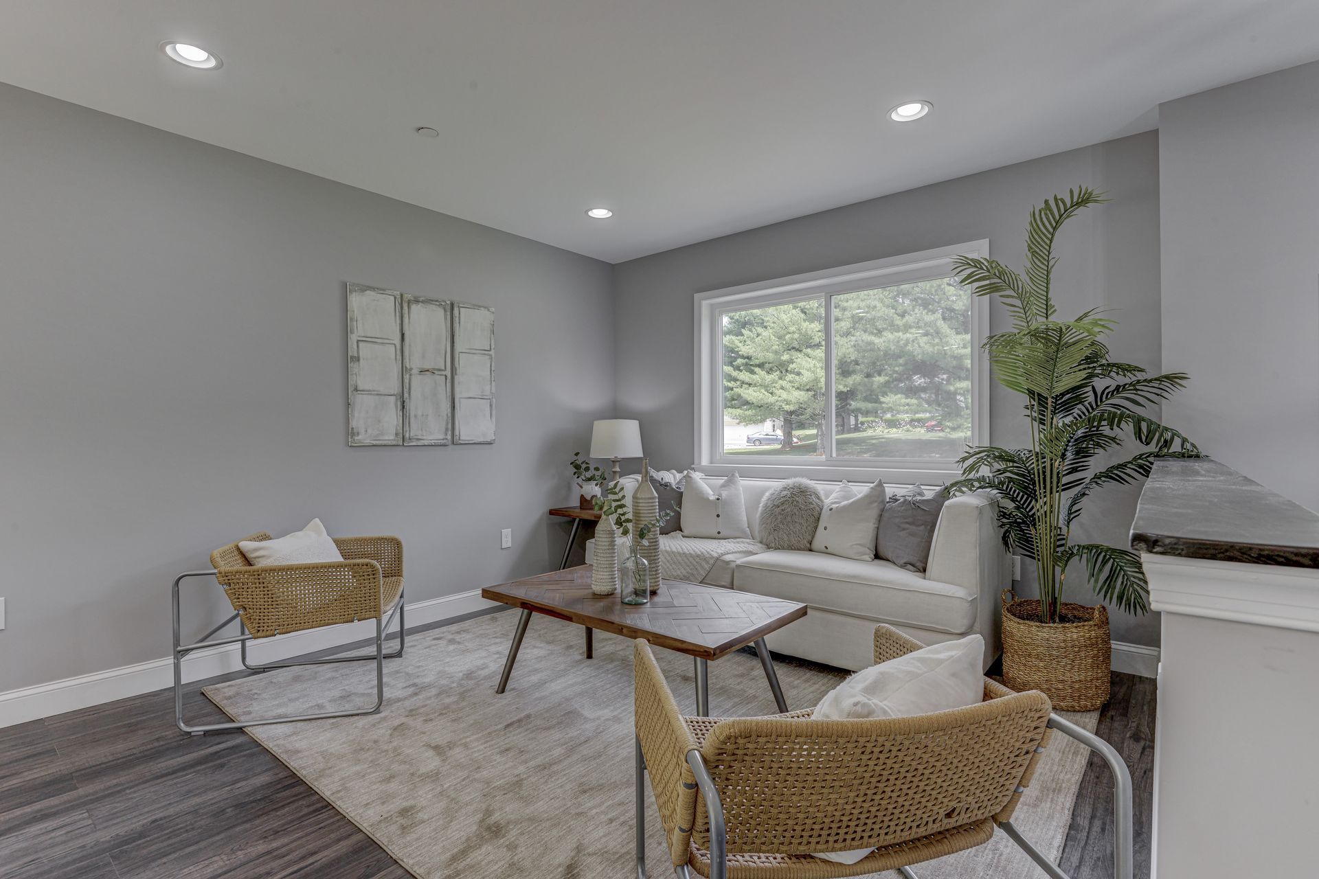 A living room with a couch , chairs , and a coffee table.