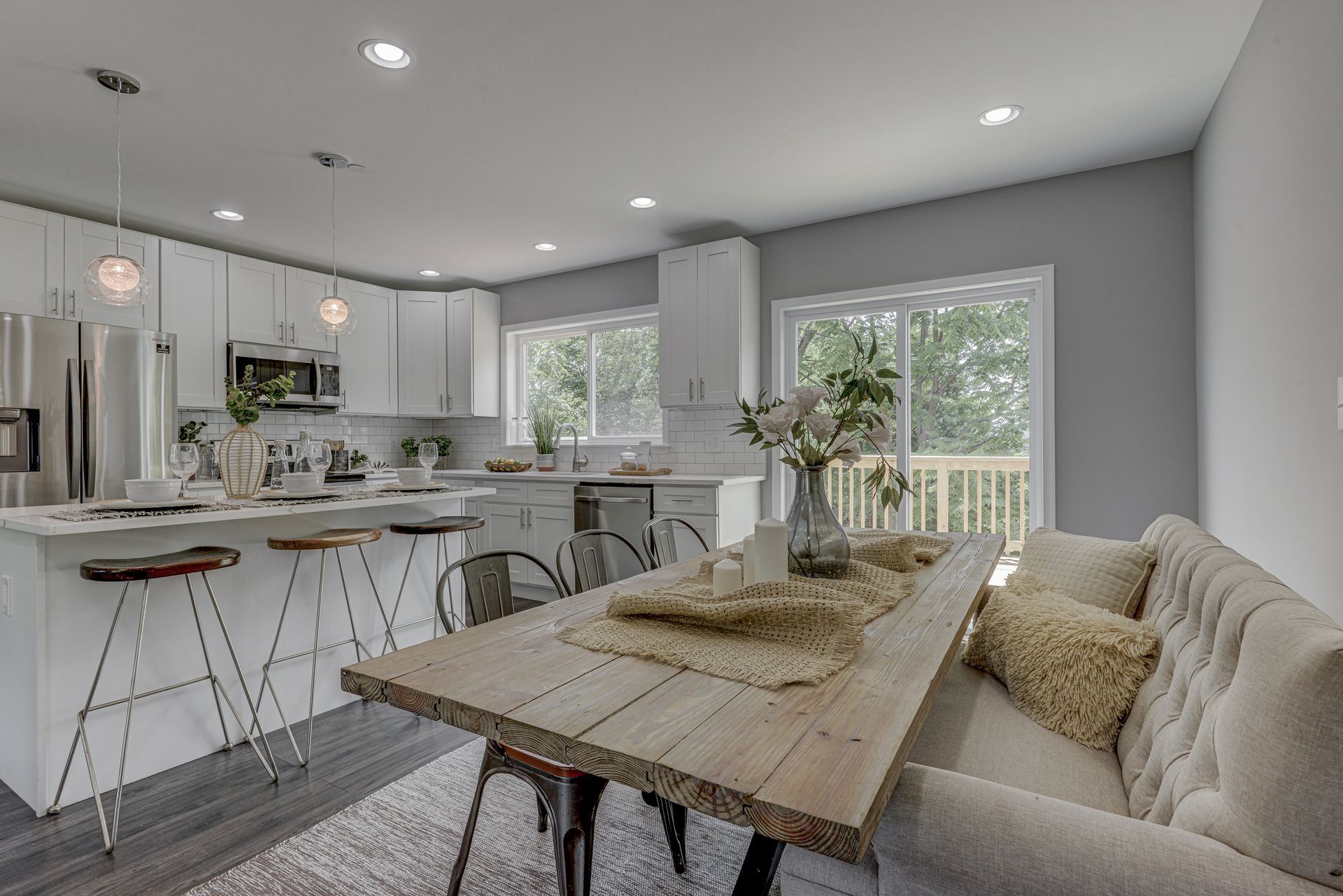 A living room with a couch , table and chairs.