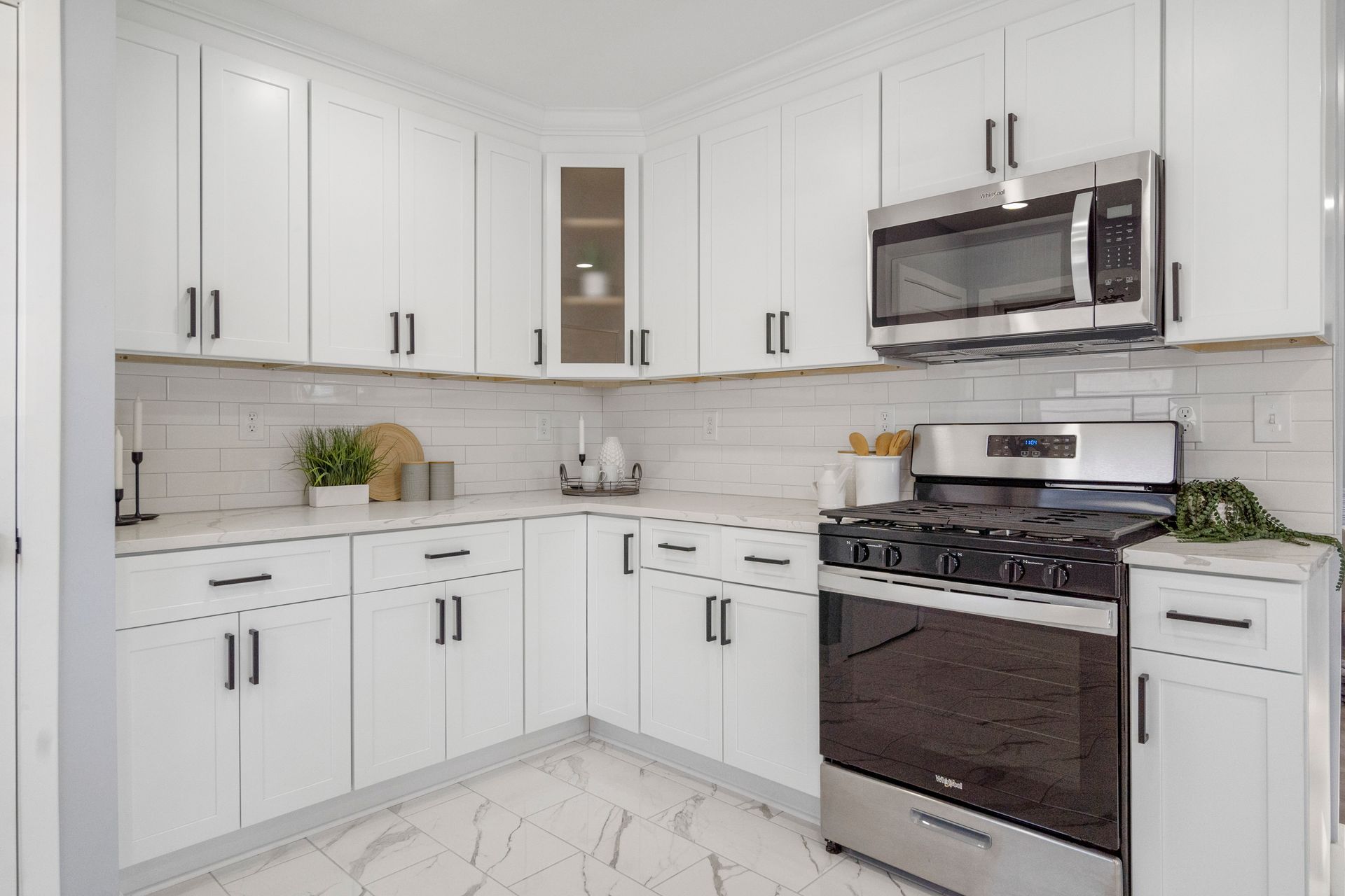 A kitchen with white cabinets and stainless steel appliances.