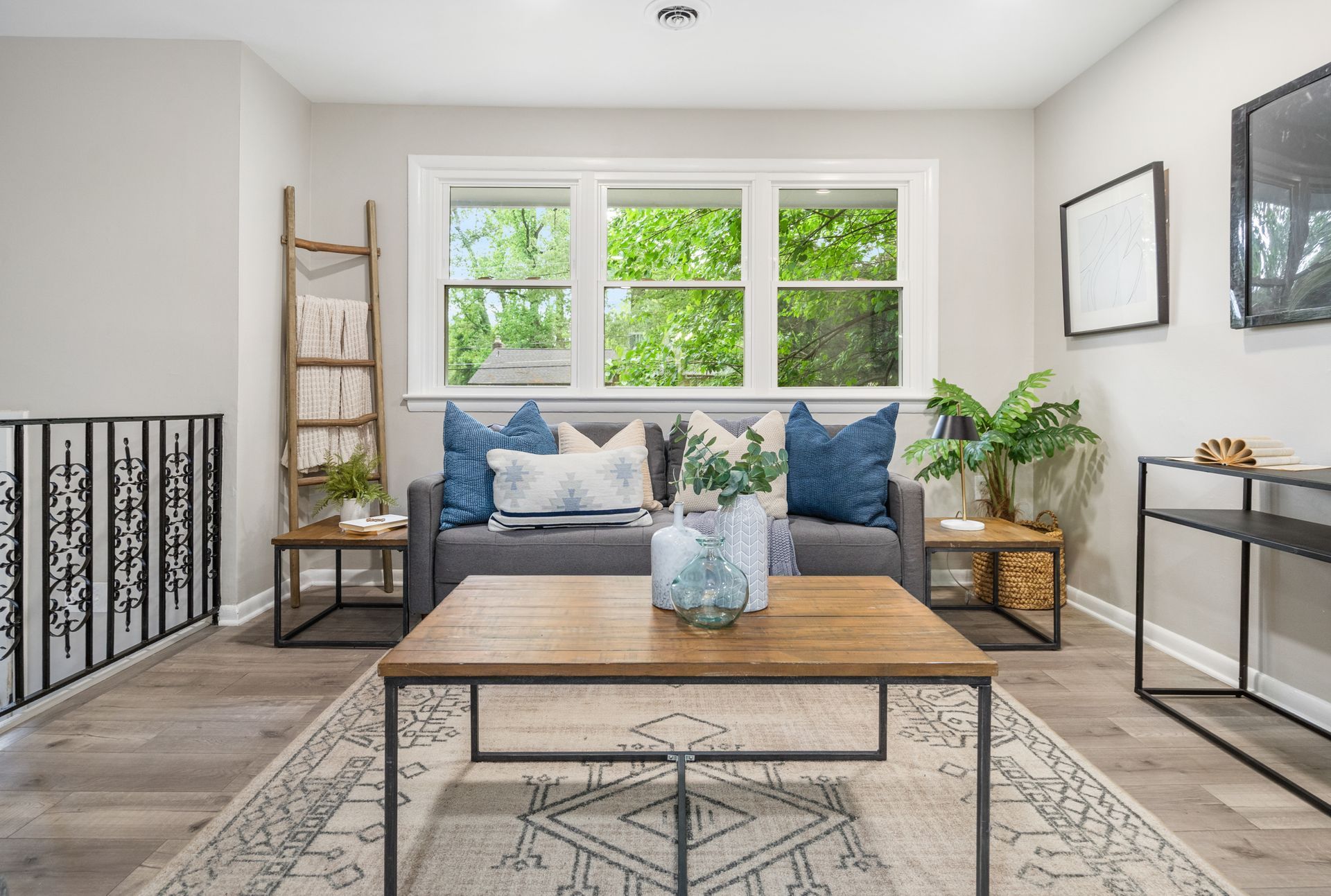 A living room with a couch , coffee table , and rug.