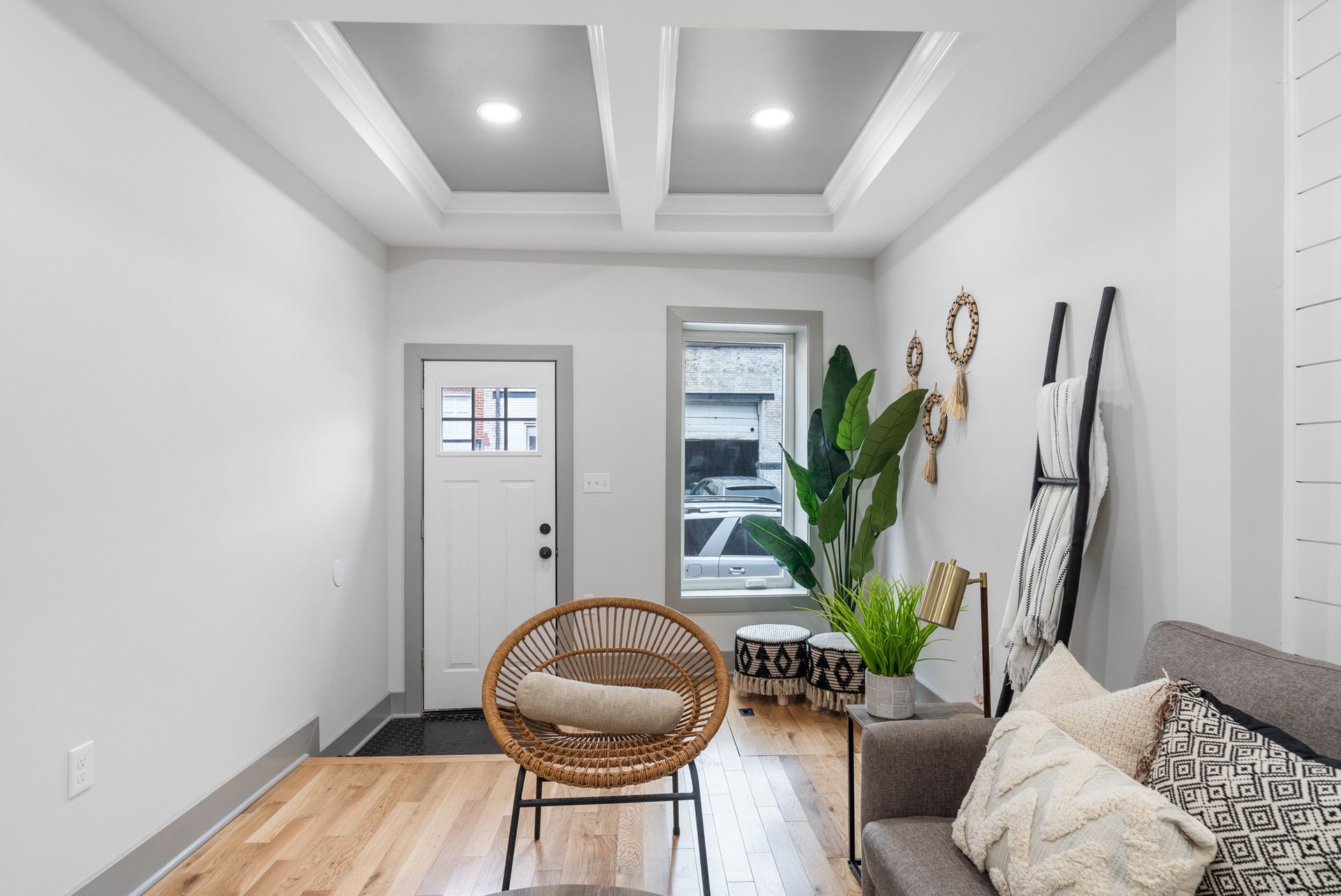 A living room with a couch , chair , and plant.