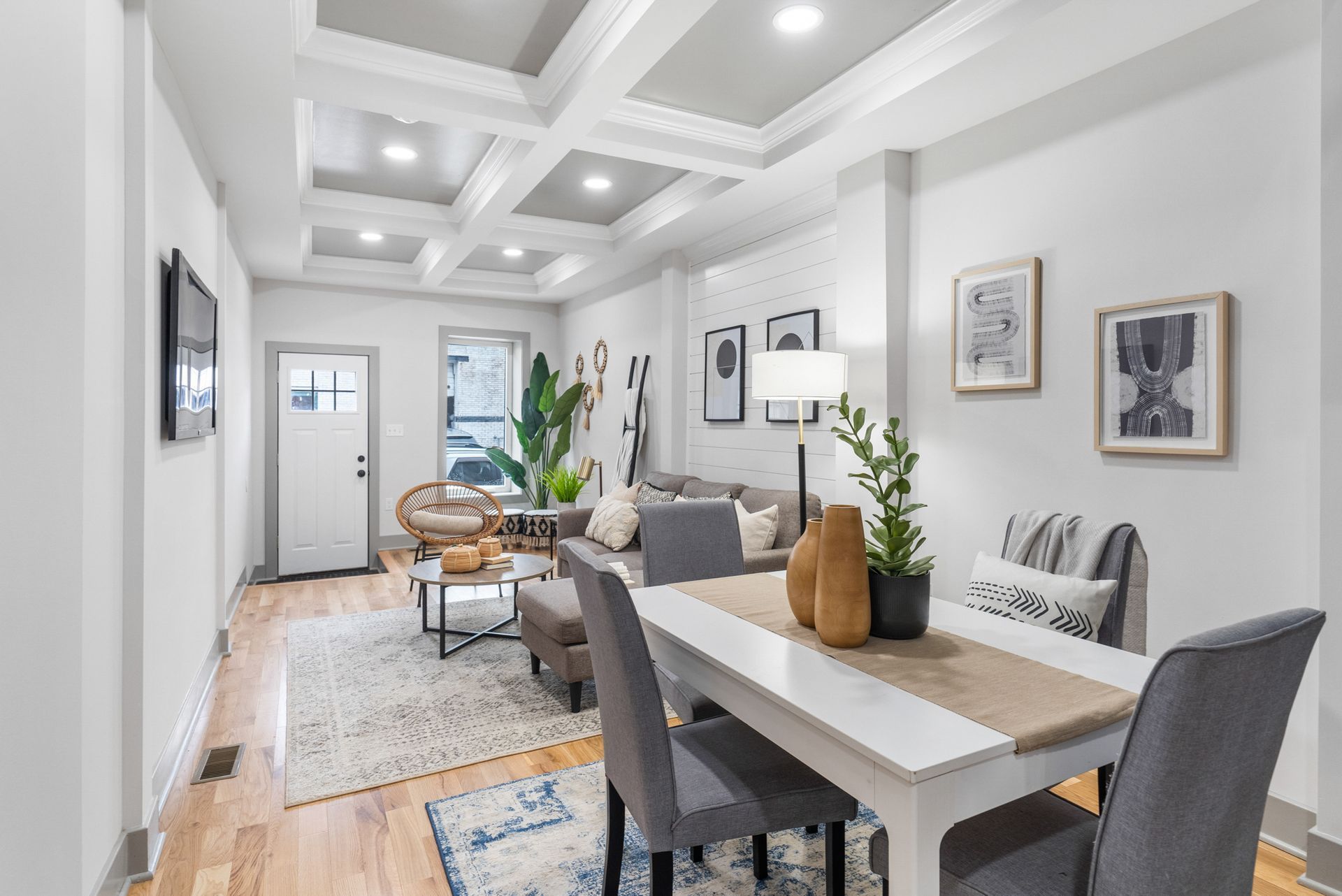 A living room with a dining table and chairs and a couch.
