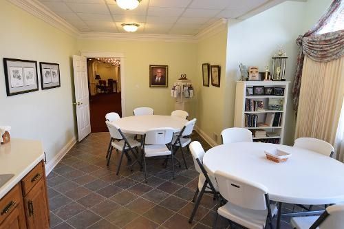 A room with a table and chairs in it