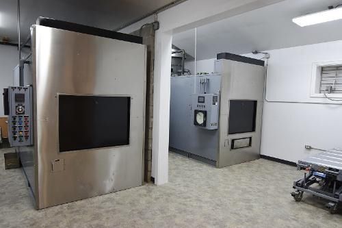 A room with a lot of stainless steel appliances in it.