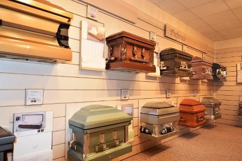 There are many different types of coffins on display in this room.