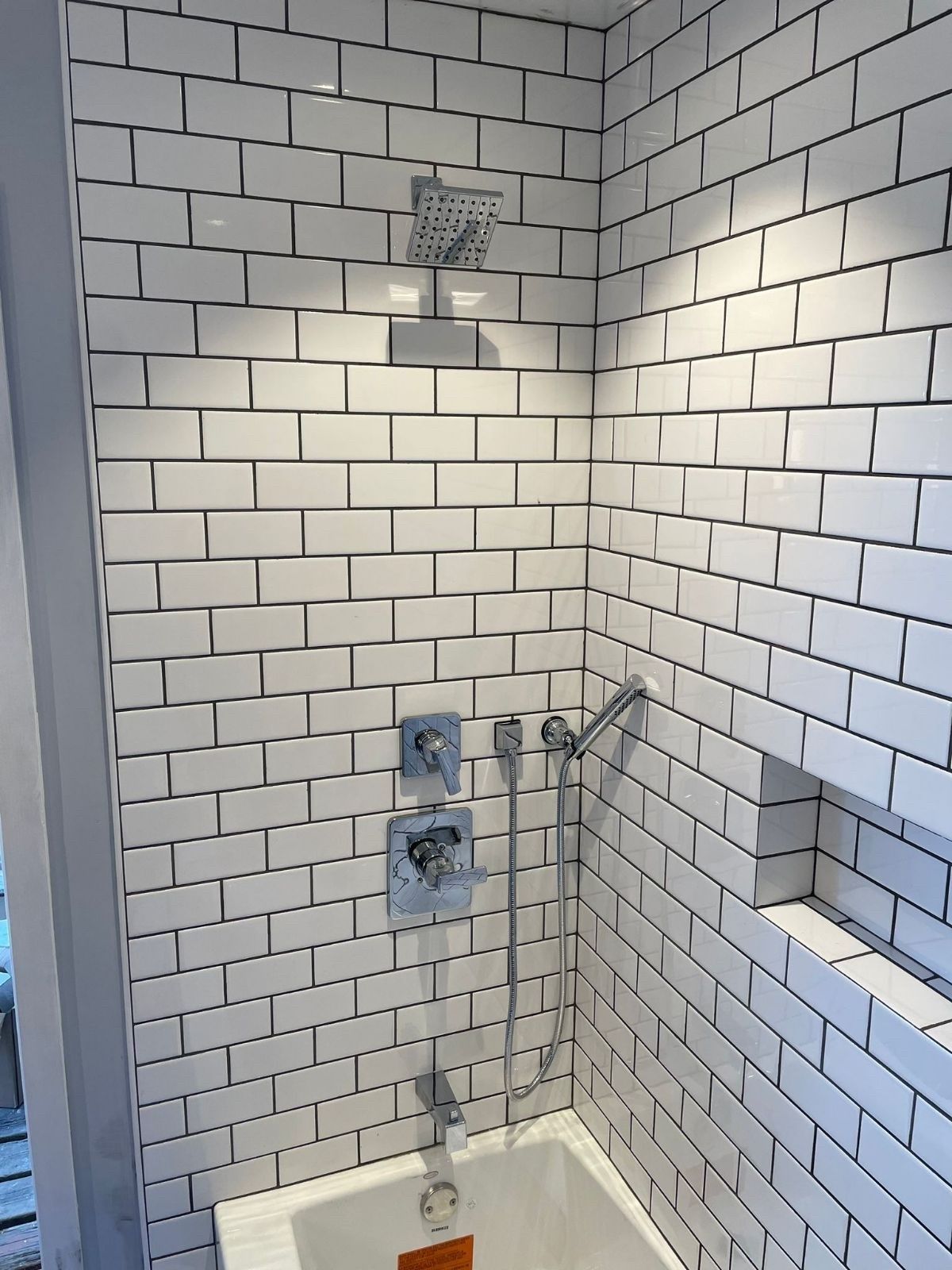 A row of blue pipes with red valves in a factory.