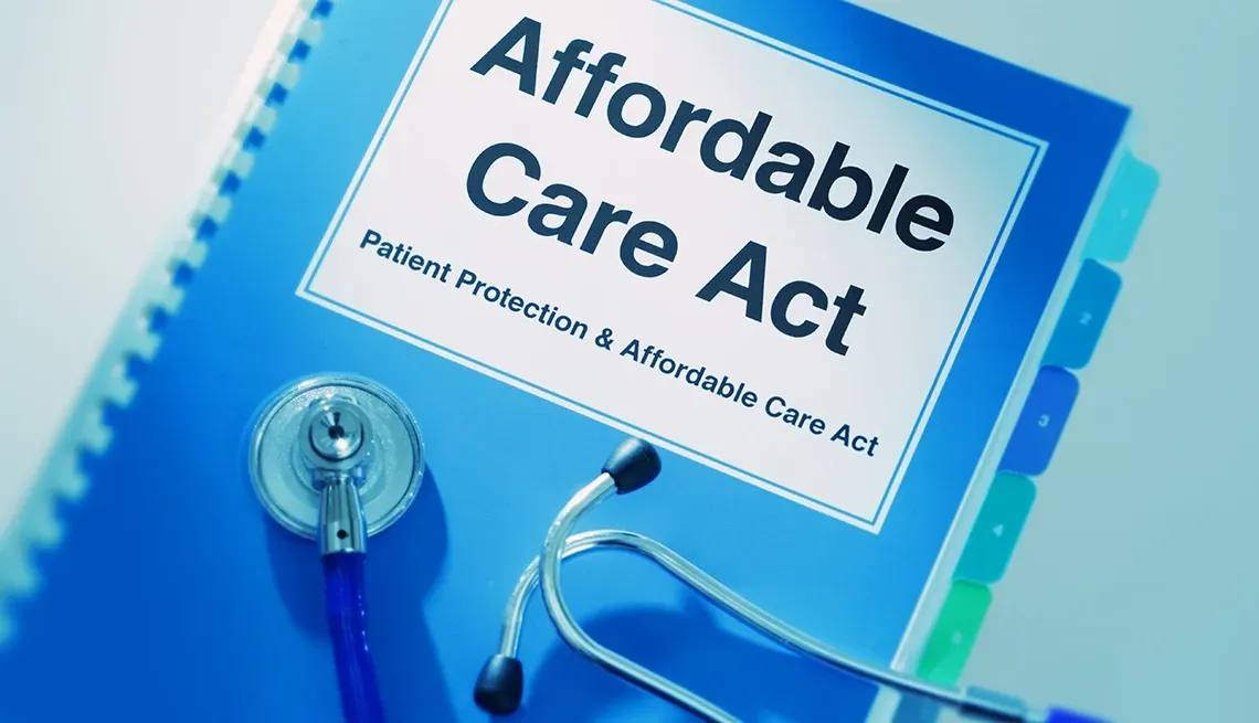 A stethoscope is sitting on top of an affordable care act book