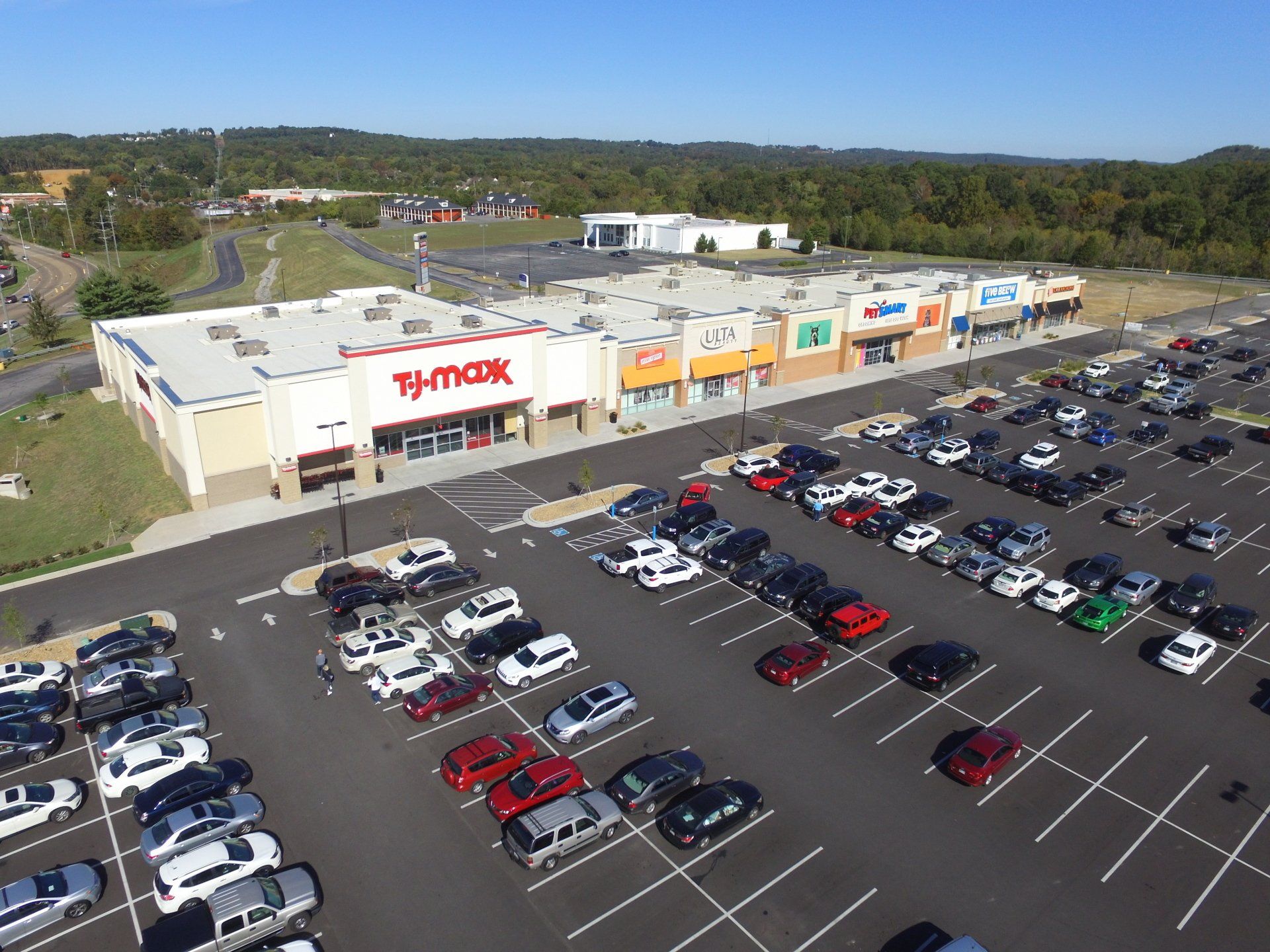 An aerial view of a parking lot in front of a store.