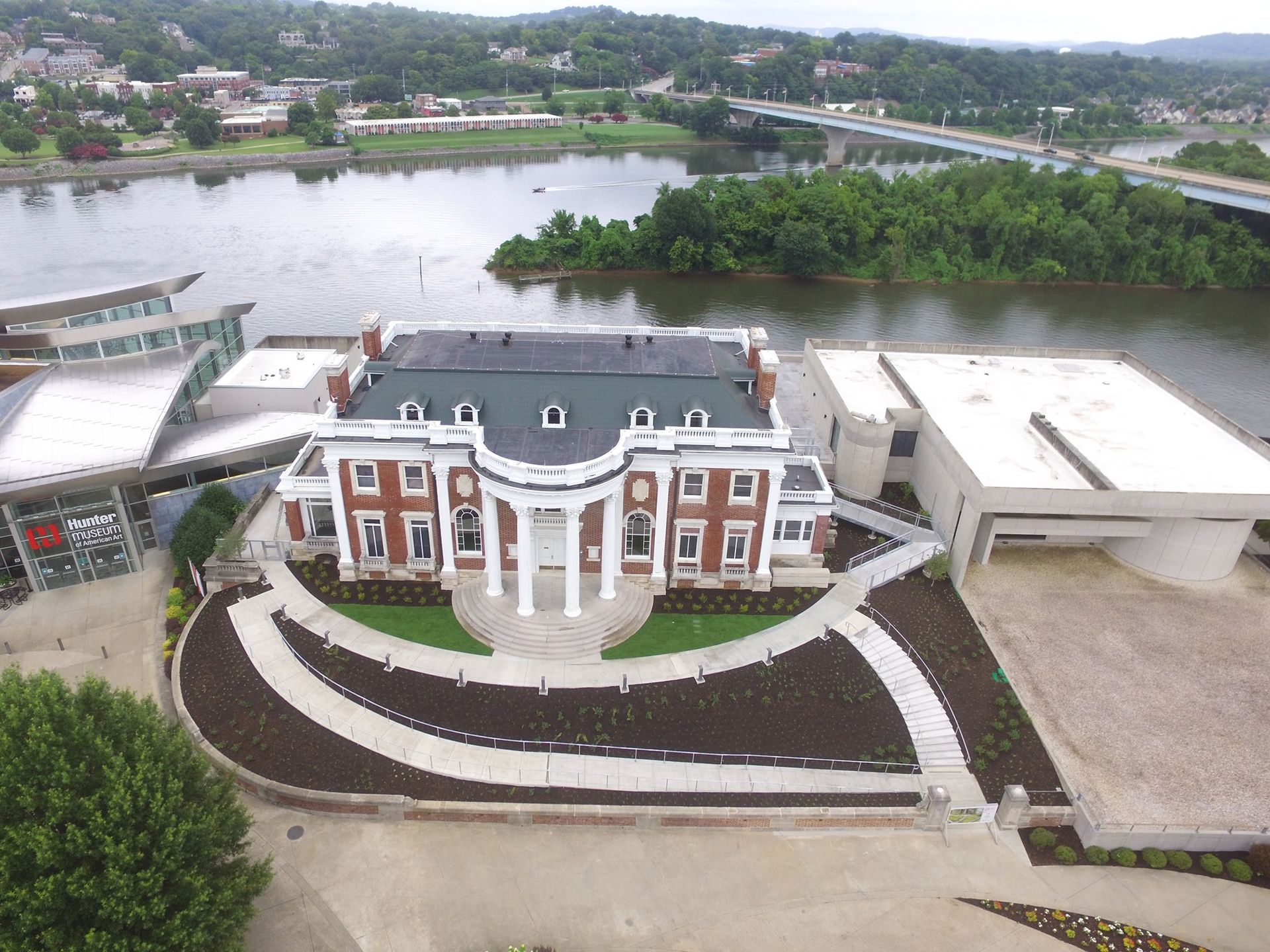 A large apartment building with a lot of windows and trees in front of it.