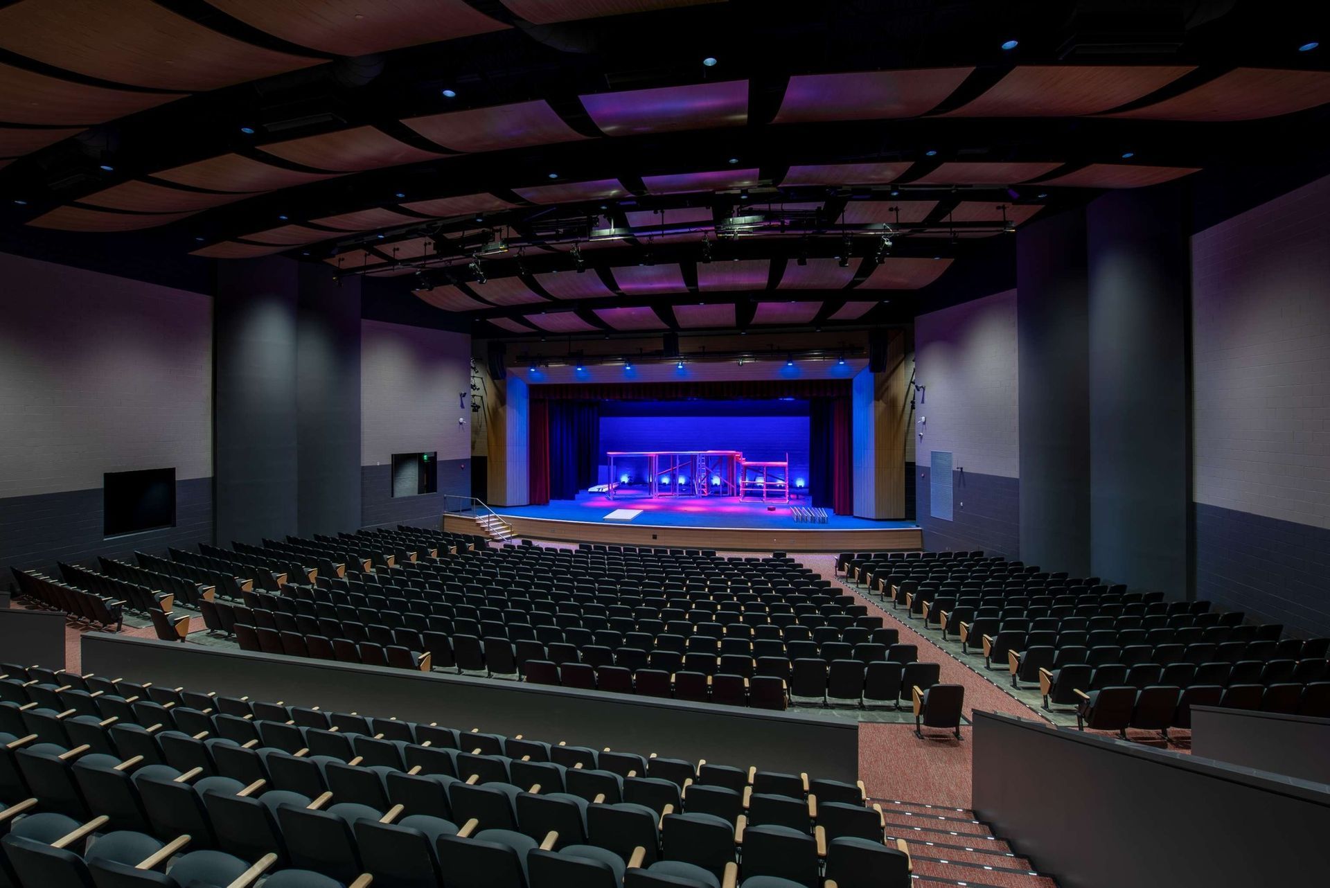 A large auditorium with rows of seats and a stage