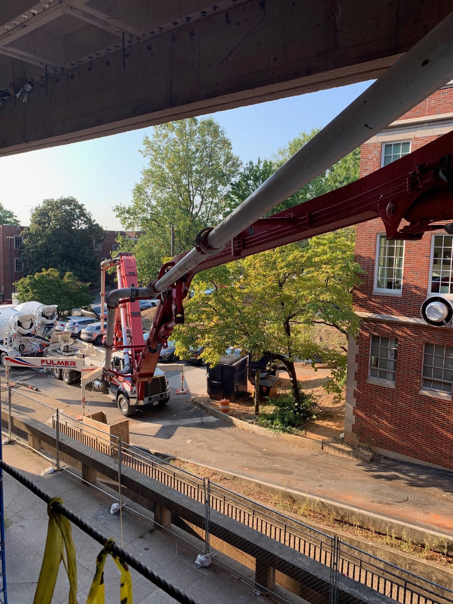 A crane is being used to pour concrete into a building.