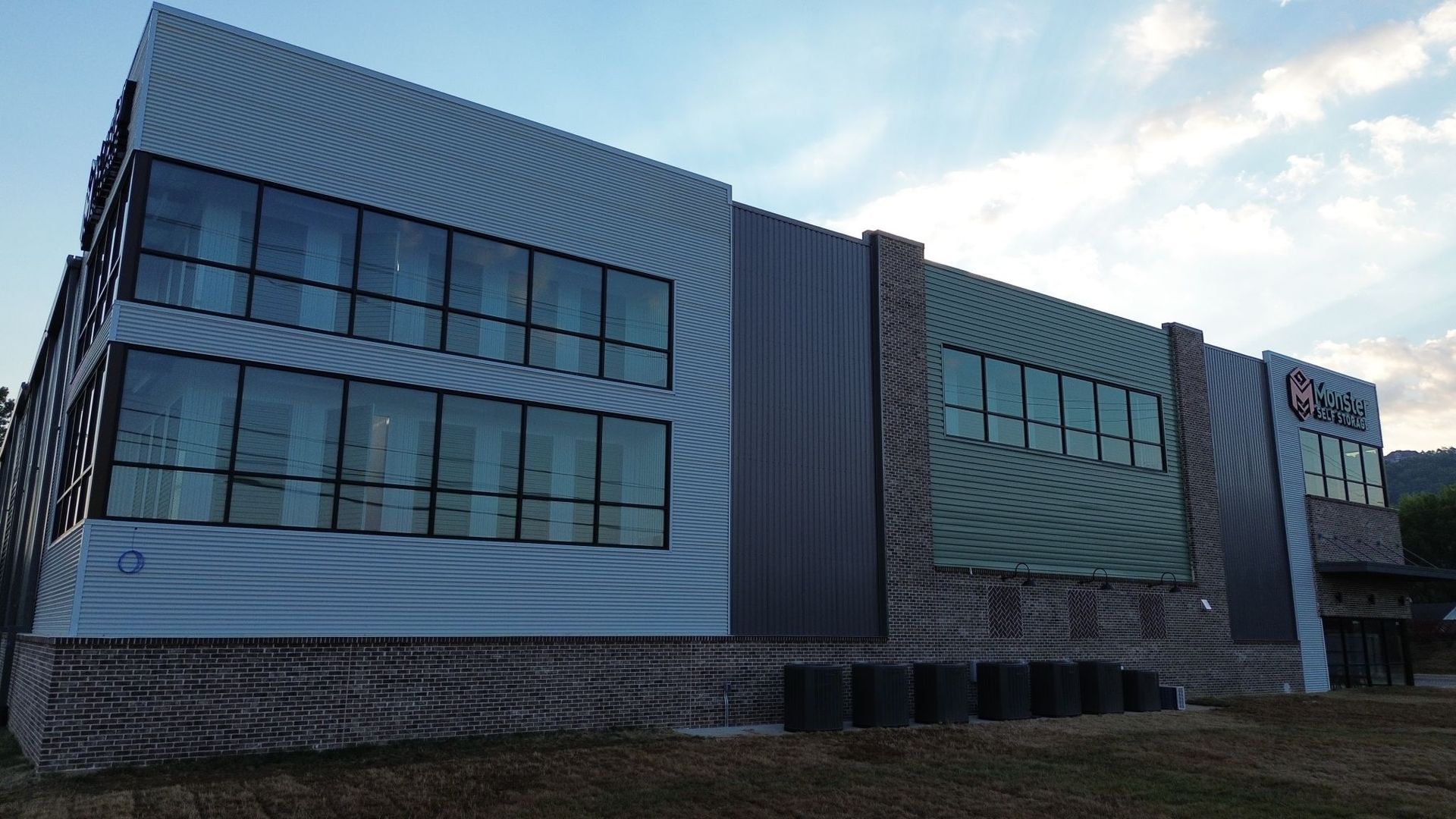 A large building with a lot of windows and a brick wall.