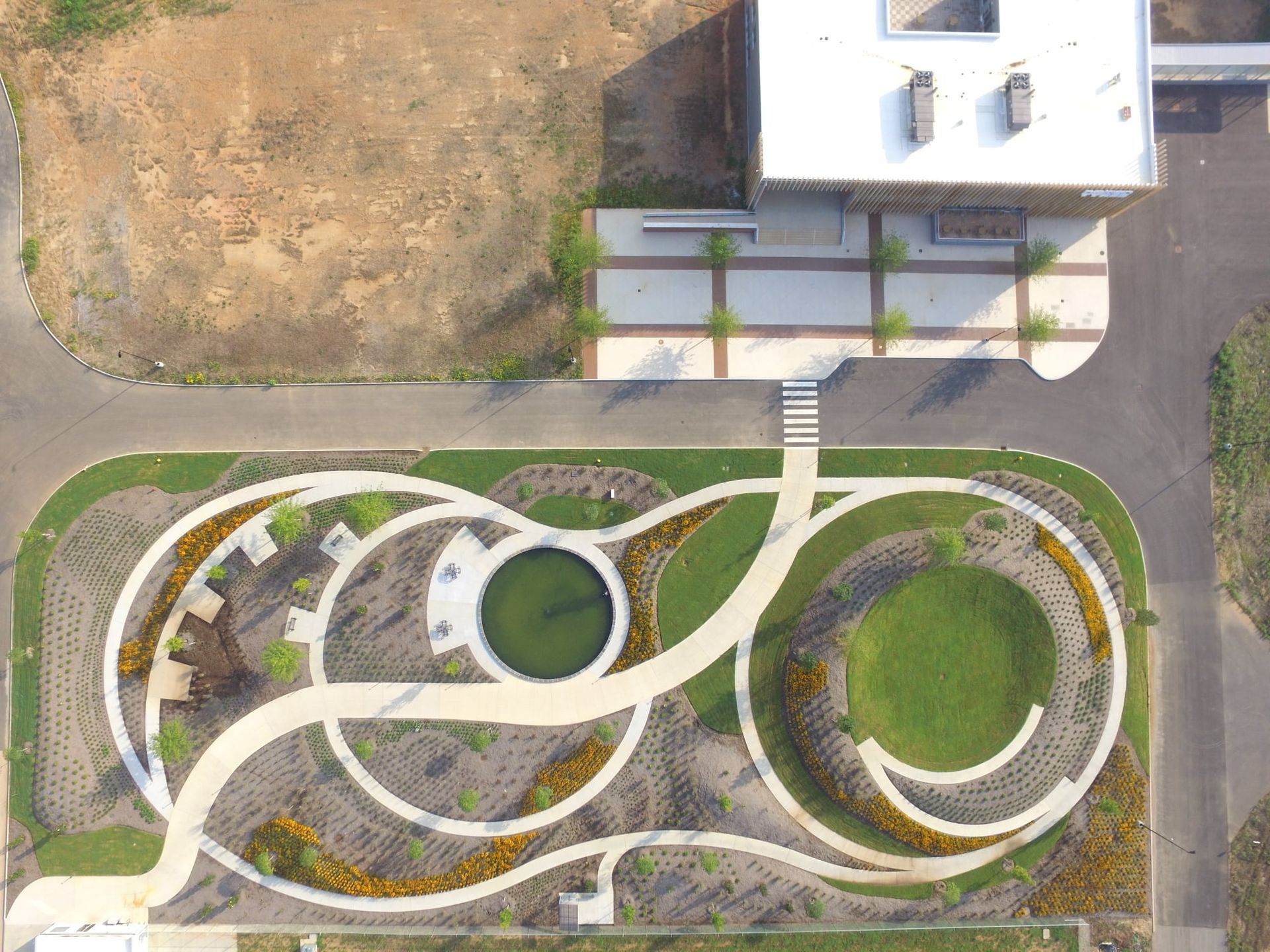 An aerial view of a park with a building in the background