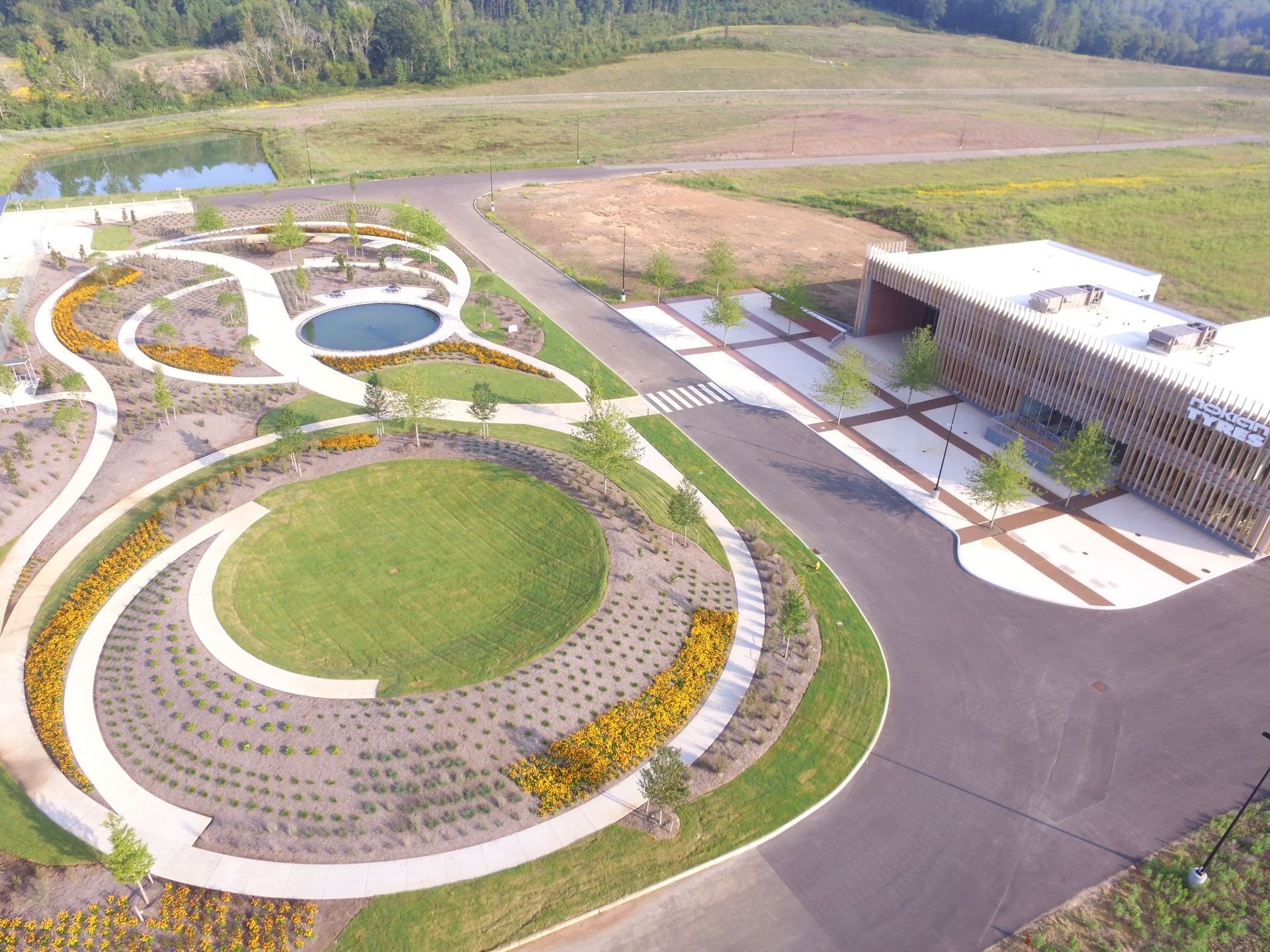 An aerial view of a park with a building in the background