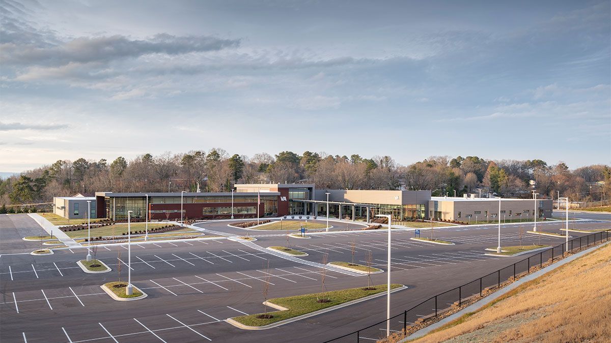 A large building with a lot of parking spaces in front of it.