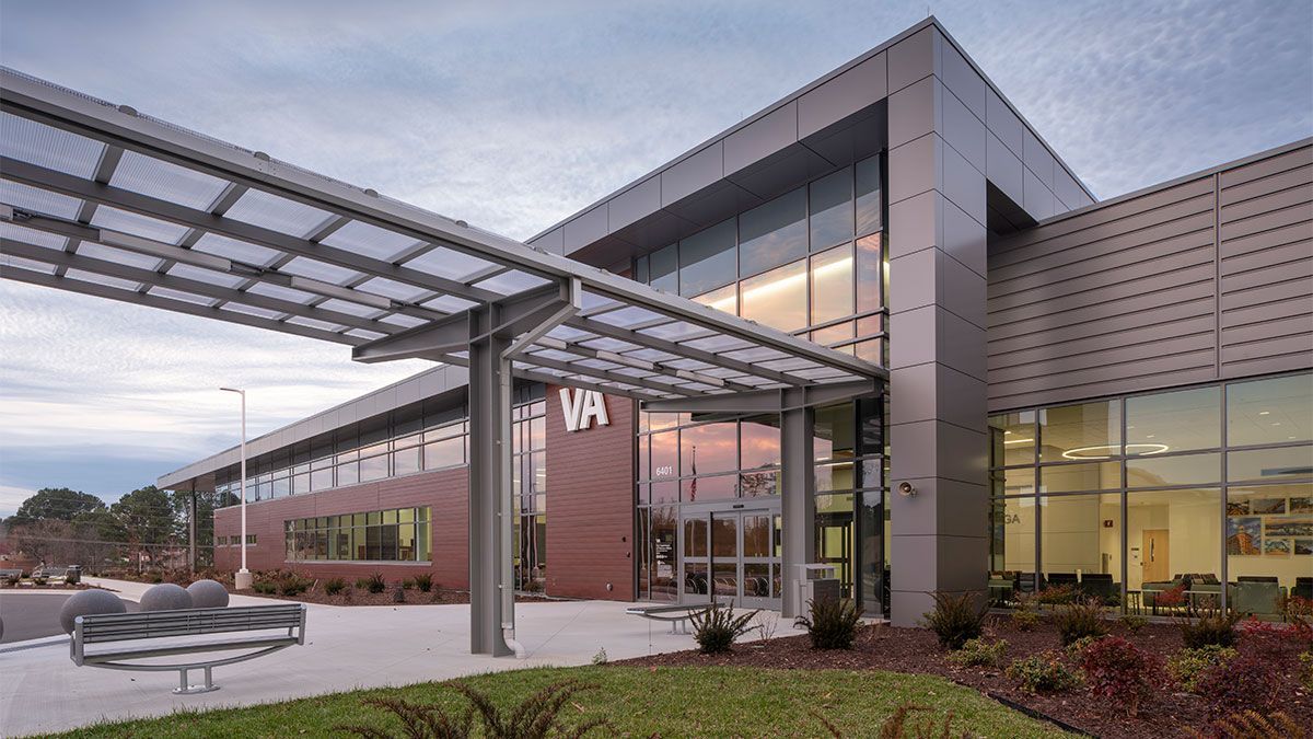 A large building with a lot of windows and a canopy over the entrance.