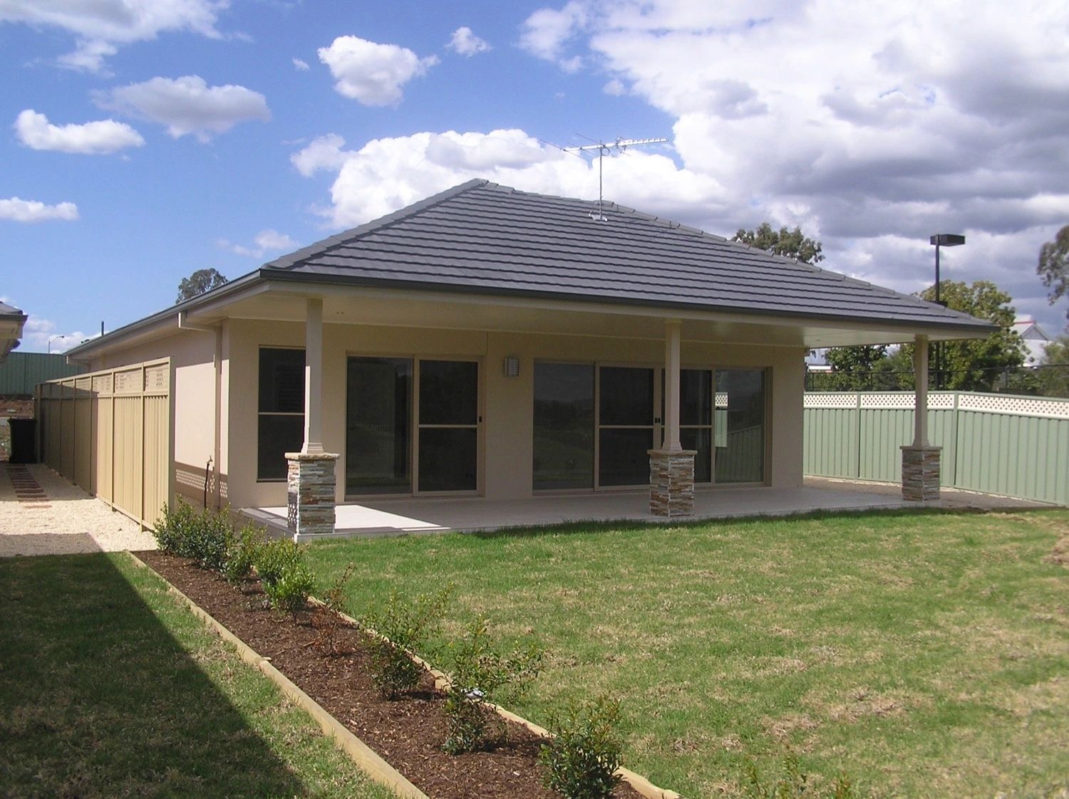 A house with a large lawn in front of it