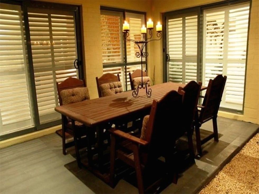 A table and chairs in a room with sliding glass doors