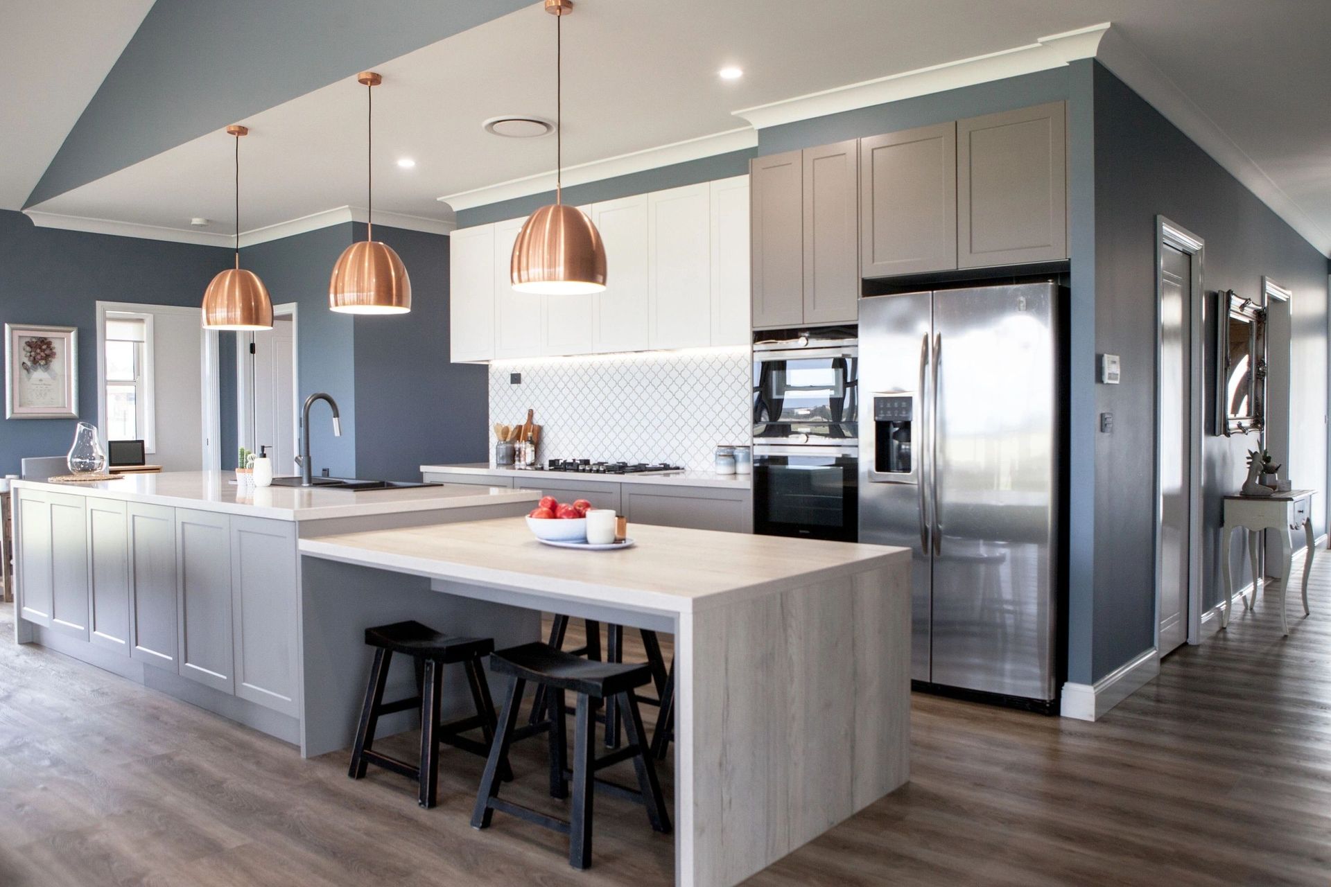A kitchen with stainless steel appliances and a large island.