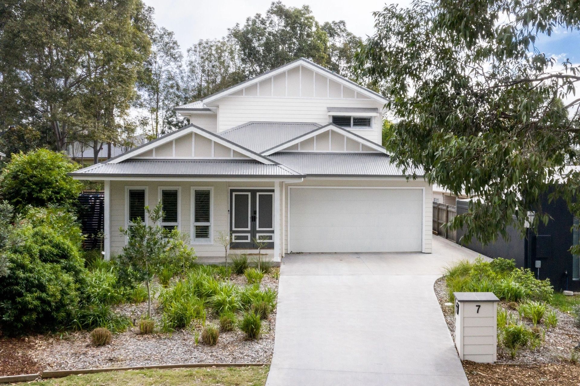 A white house with a driveway leading to it