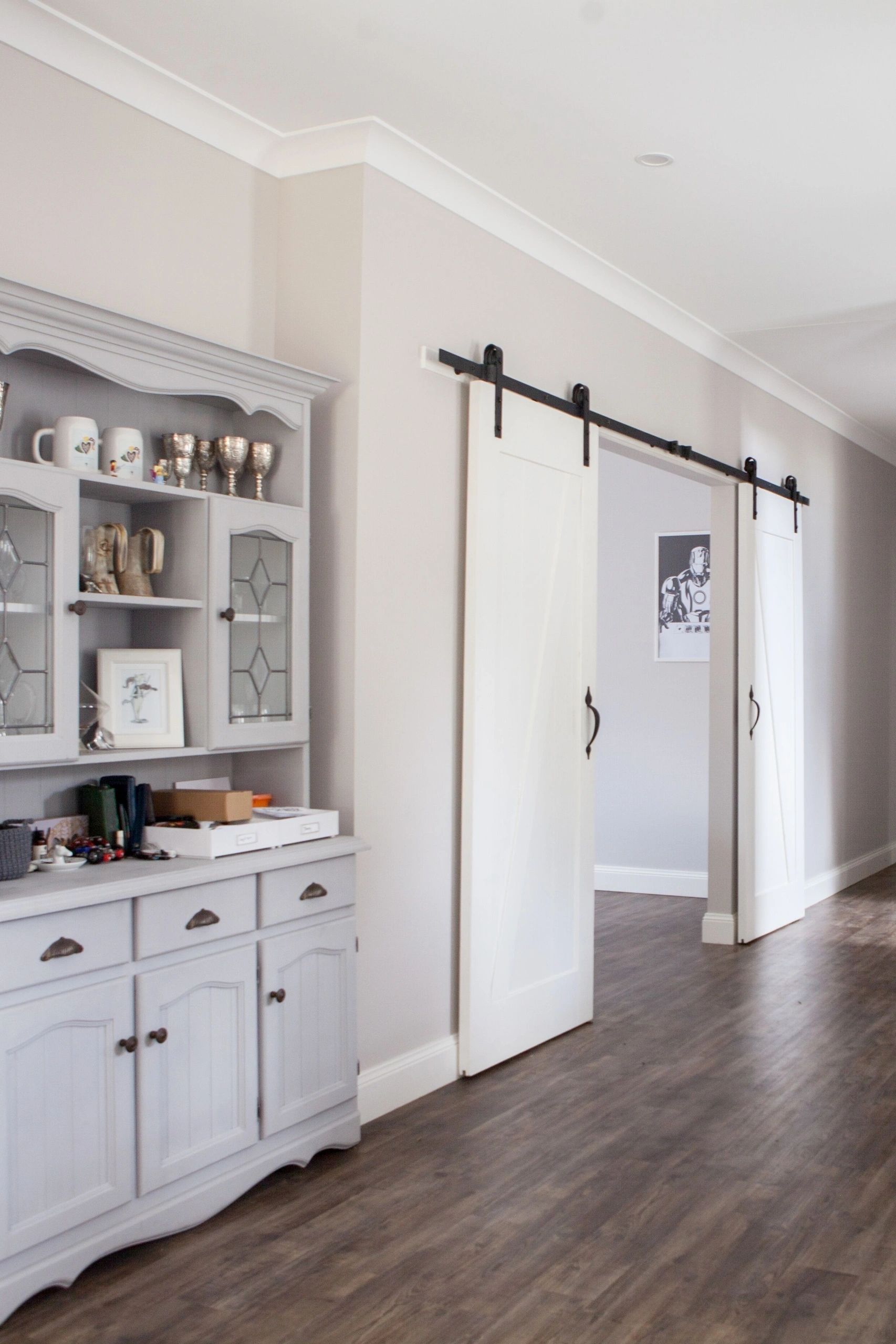 A hallway with a hutch and sliding barn doors