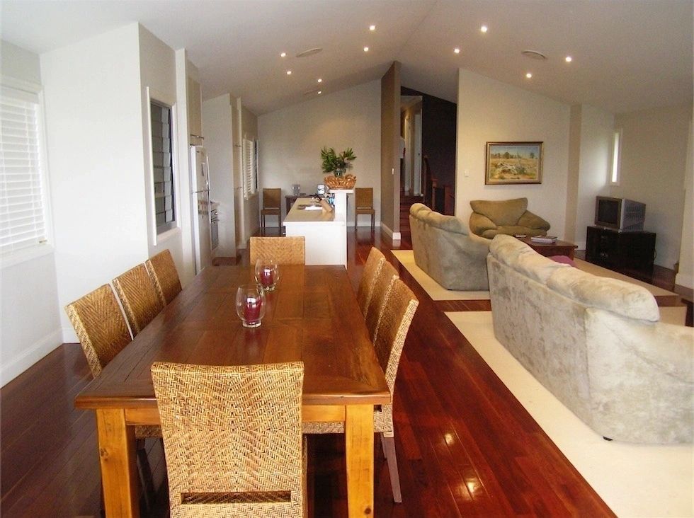 A living room with a dining table and chairs