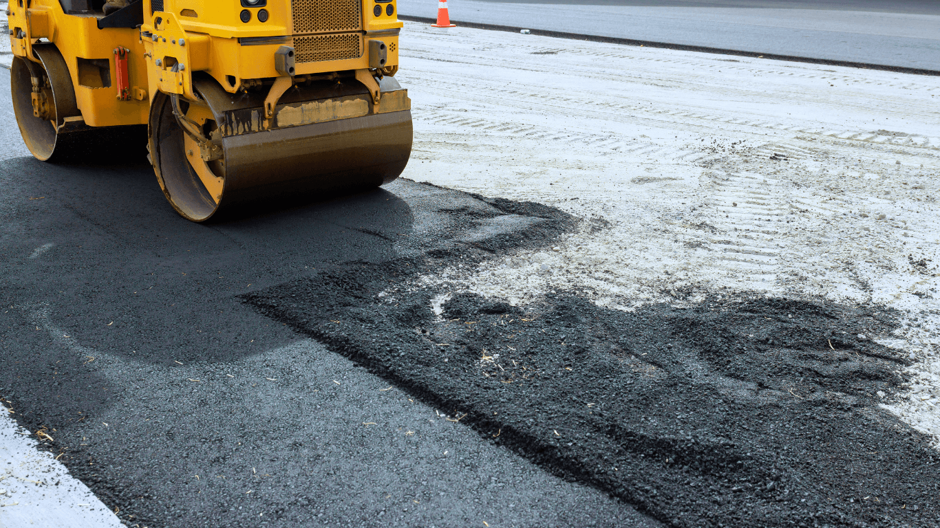 an asphalt contractor paving a road