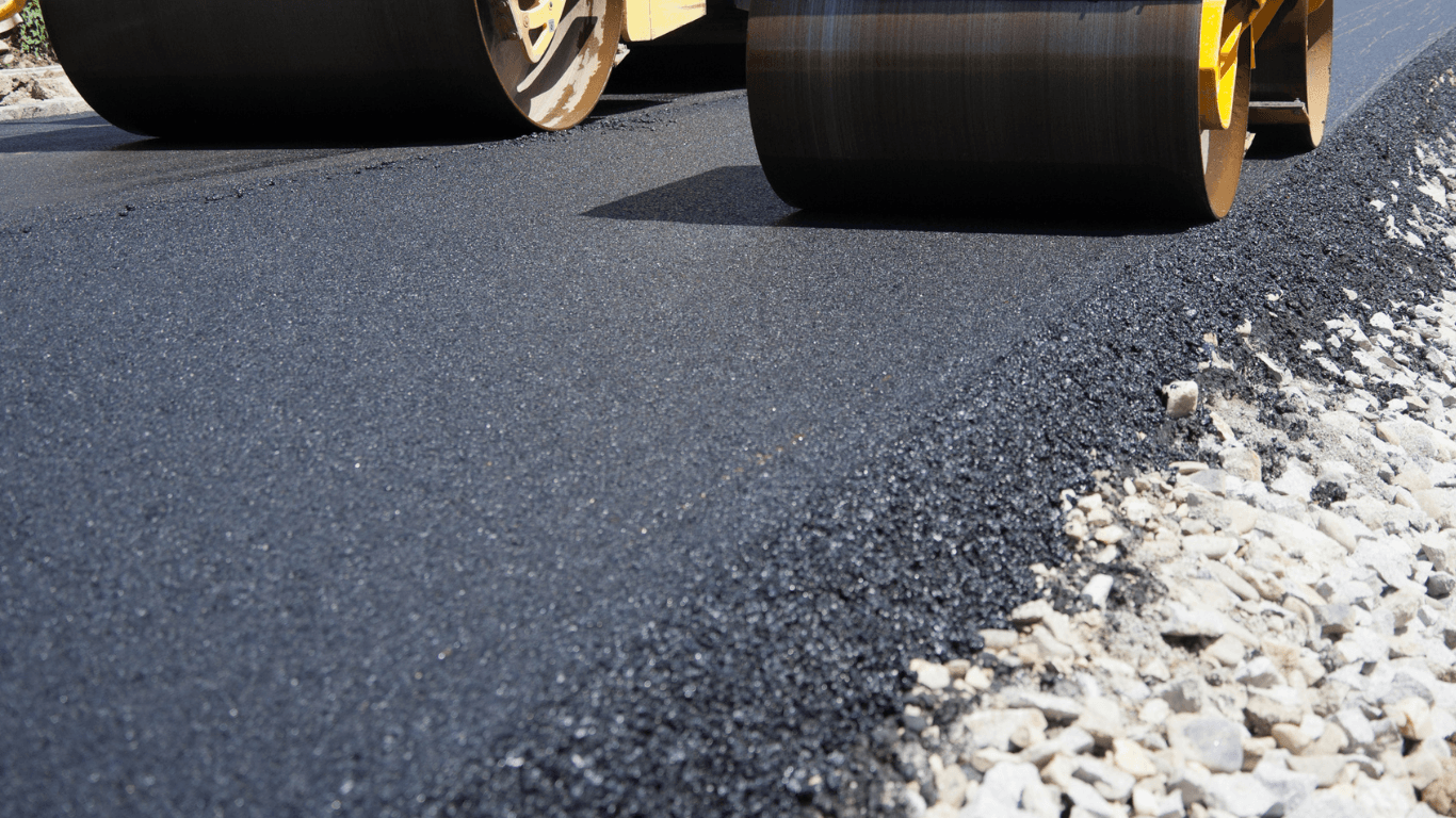 an asphalt company paving a surface