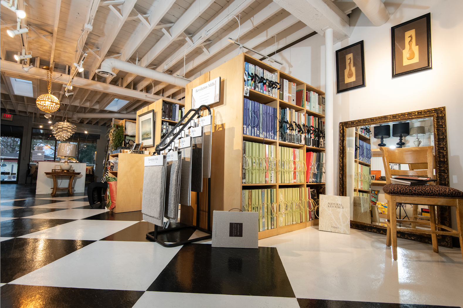 A large room with a checkered floor and shelves filled with books.
