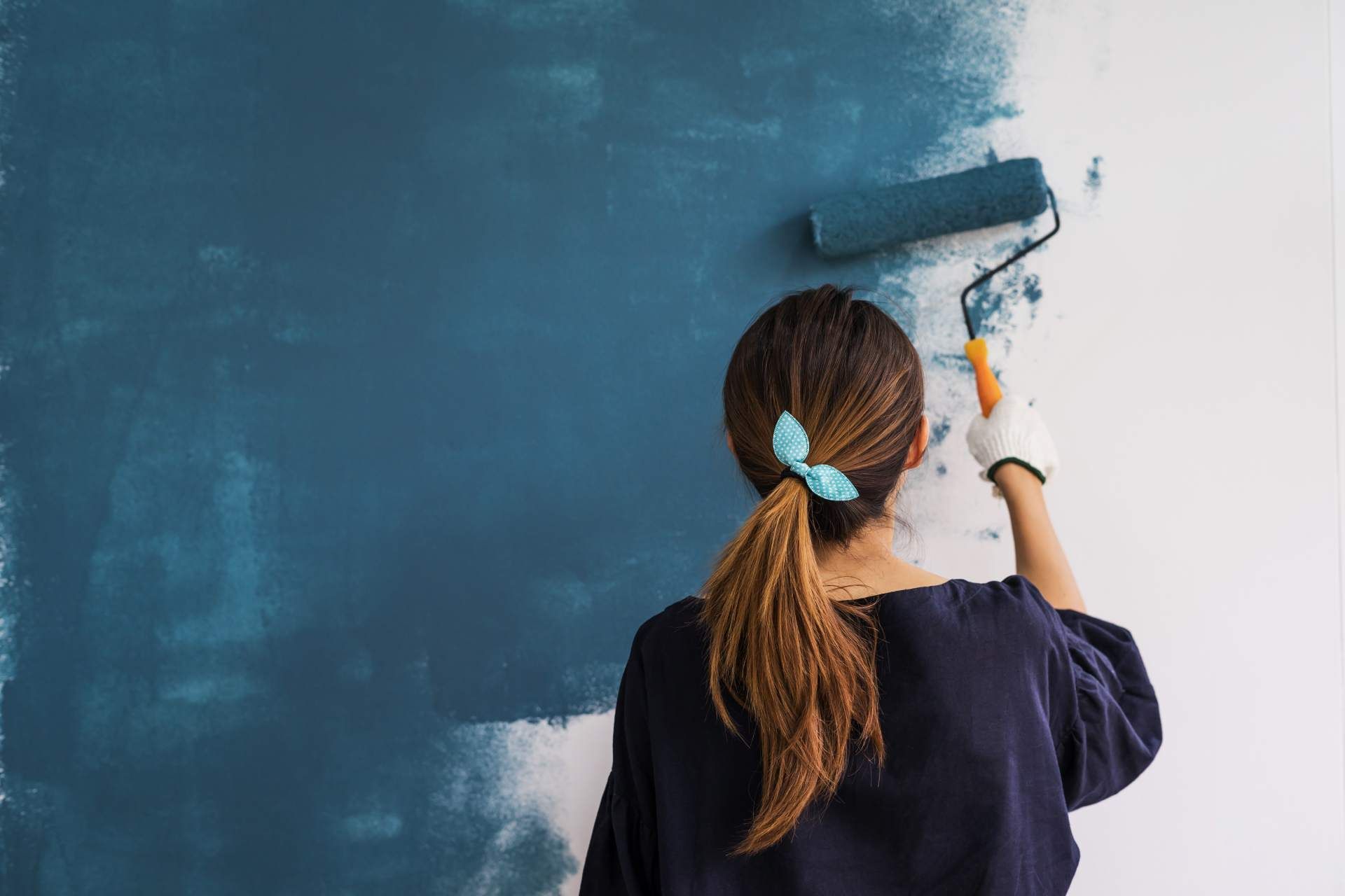 Image of a person painting a spackled wall