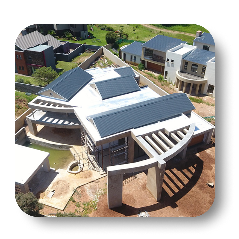 Aerial view of a modern home under construction with a grey roof.