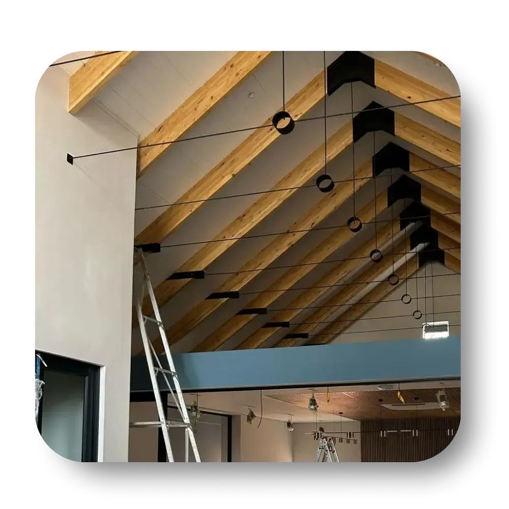 Wooden beam ceiling with black metal accents, interior, ladder.