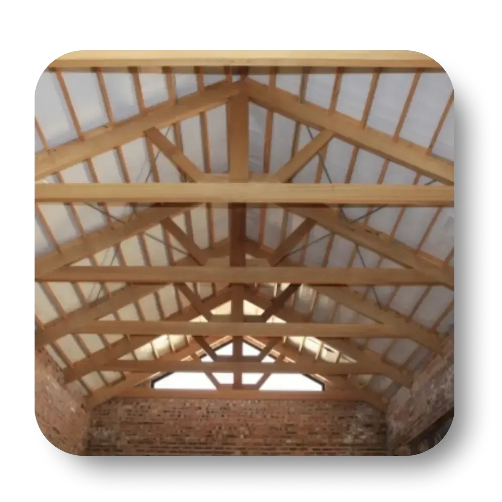 Wooden roof truss construction over brick walls.