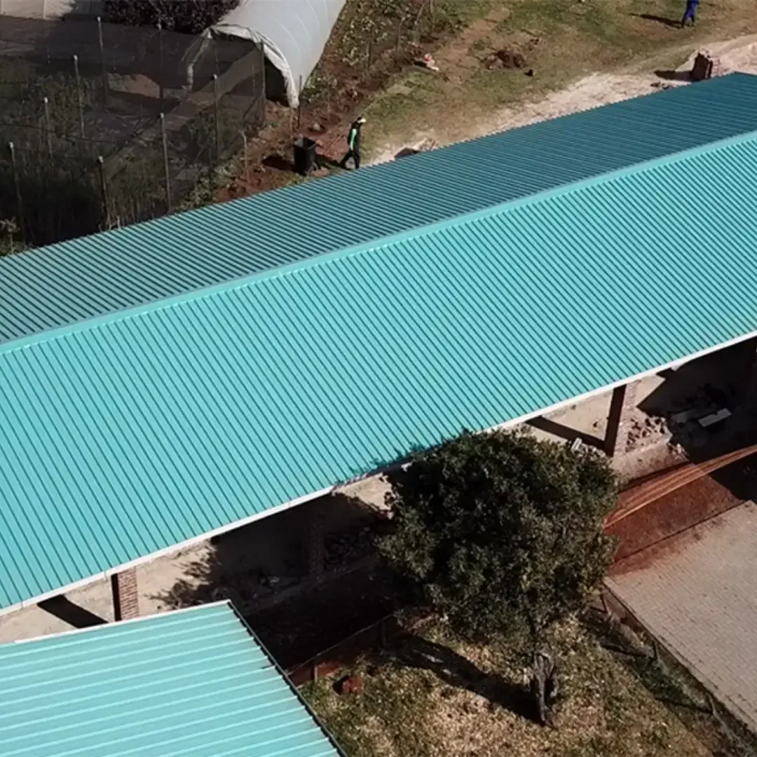 Blue metal roof on a building, aerial view.