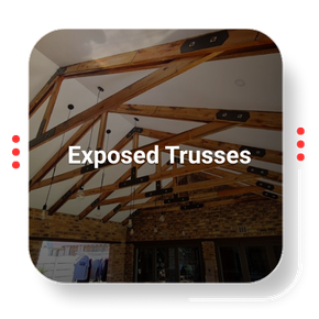 Exposed wooden roof trusses, interior view with brick and white ceiling, modern architecture.