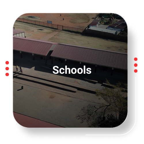 Aerial view of a school building with a red roof, labeled 