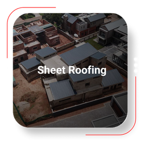 Aerial view of a residential neighborhood with sheet roofing on several buildings.