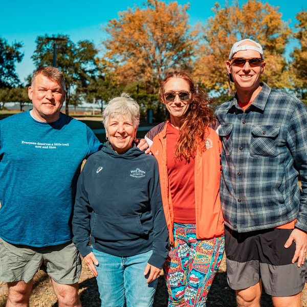 A group of people posing for a picture with one man wearing a blue shirt that says ' columbia ' on it