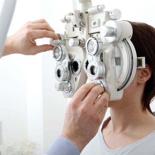 Eye Doctors — Woman Doing Eyesight Measurement with Optical Phoropter in Tucson, AZ