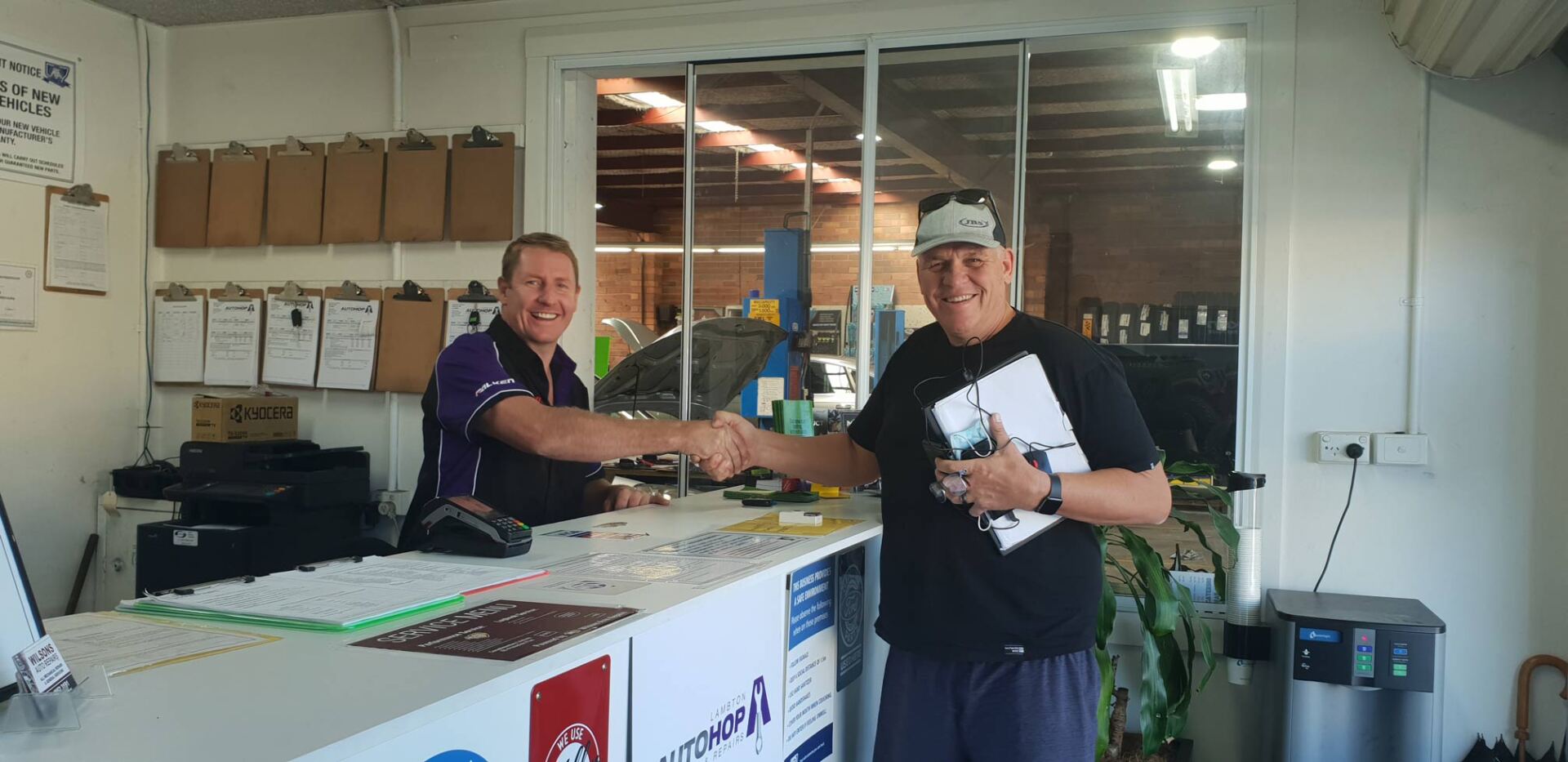 Mechanic Shaking Hands With Satisfied Customer — Servicing And Repairs in Lambton, NSW