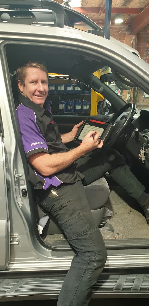 Mechanic Doing Safety Check On Vehicle — Servicing And Repairs in Lambton, NSW