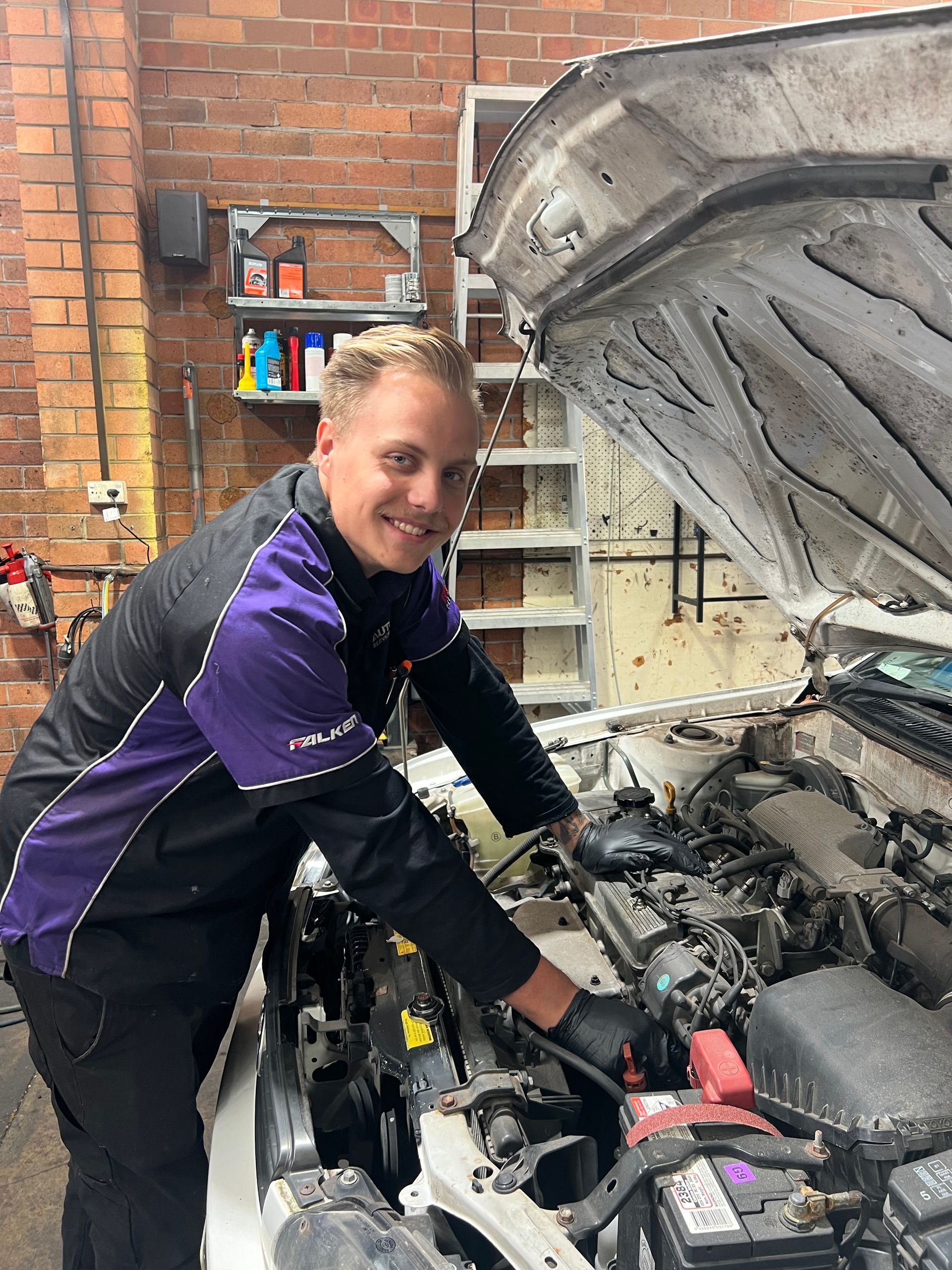 Mechanic Holding Car Hood — Servicing And Repairs in Lambton, NSW