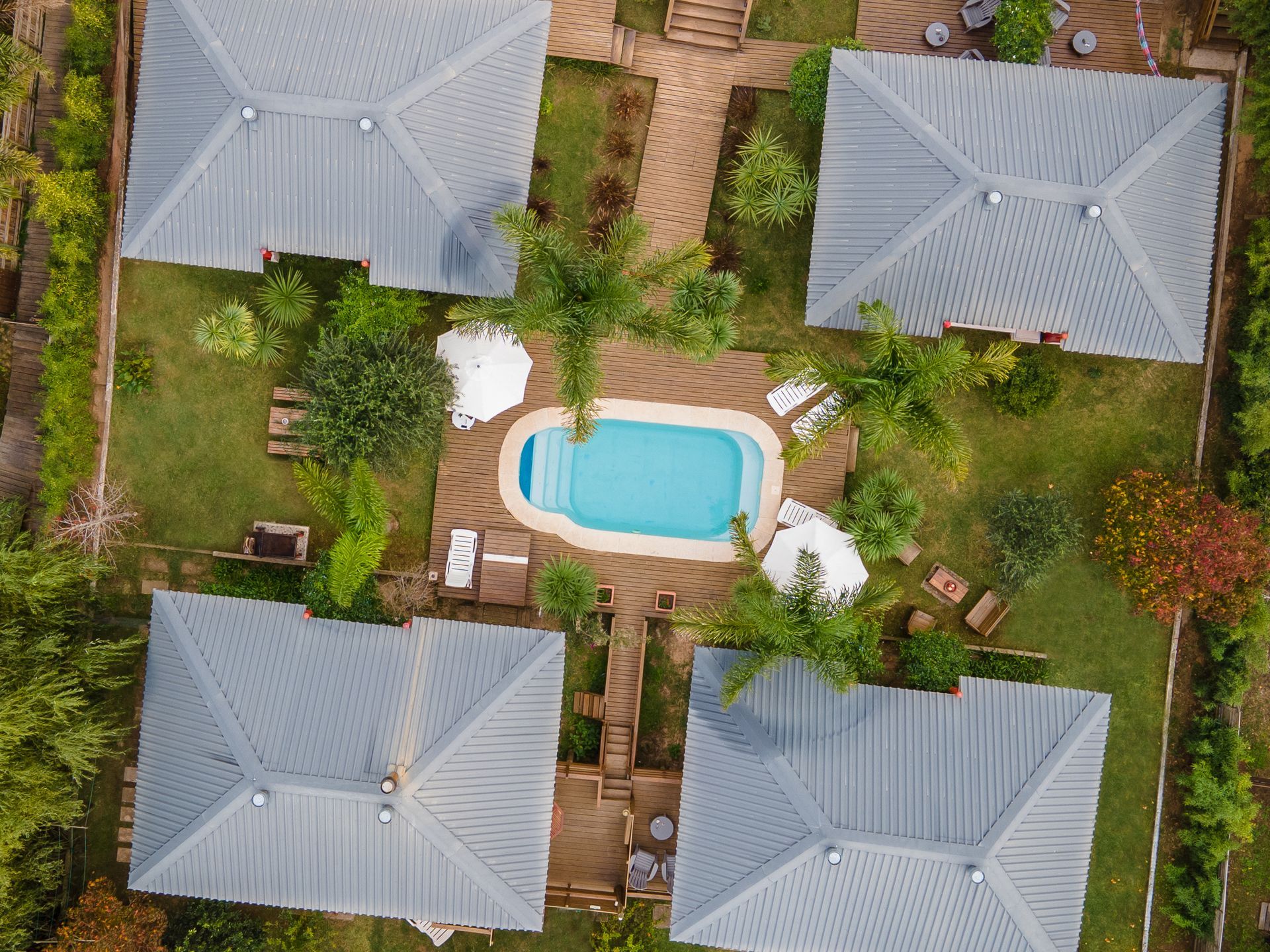 An aerial view of a house with a pool in the middle
