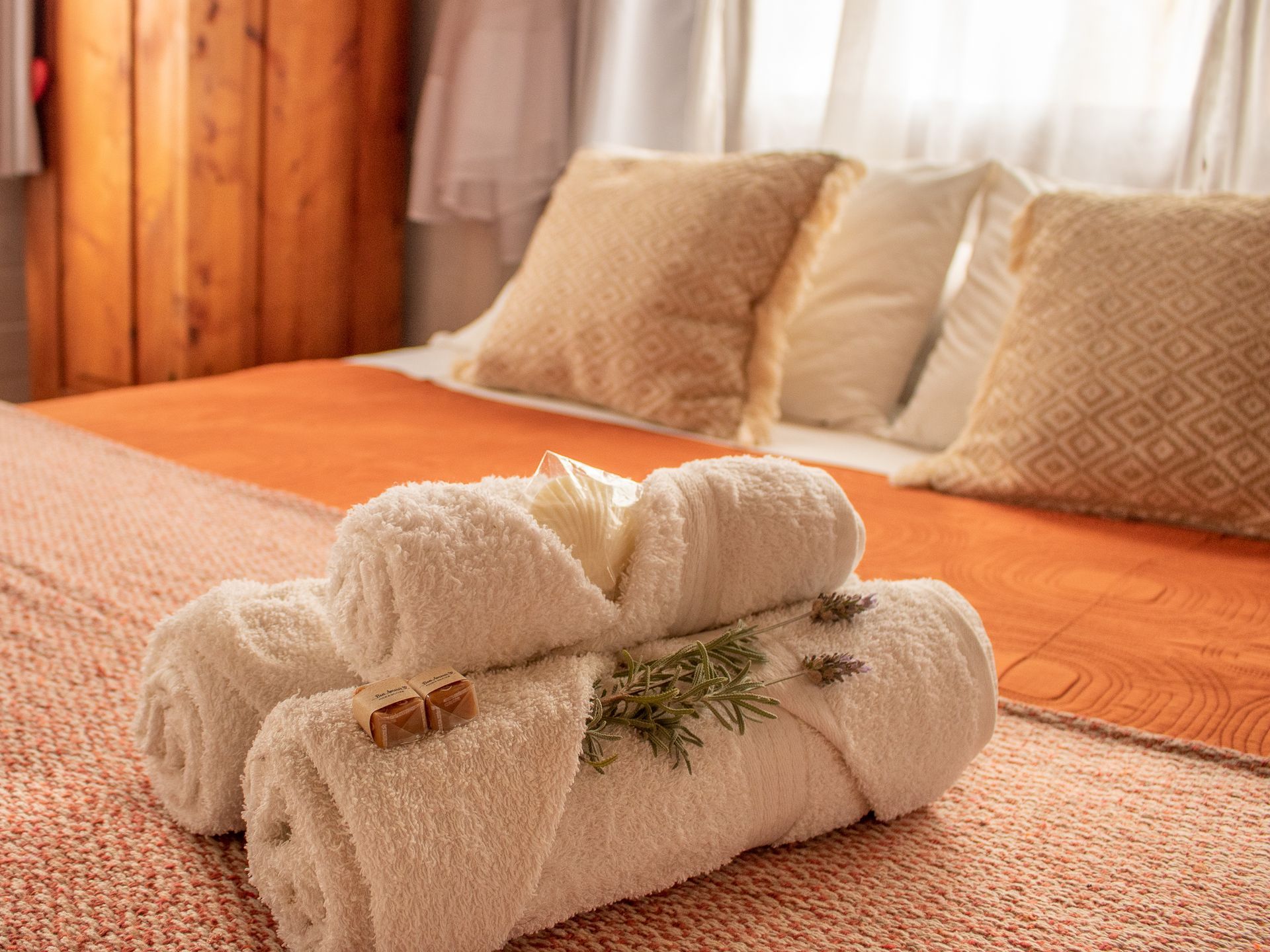 A bed with towels and pillows on it in a hotel room.