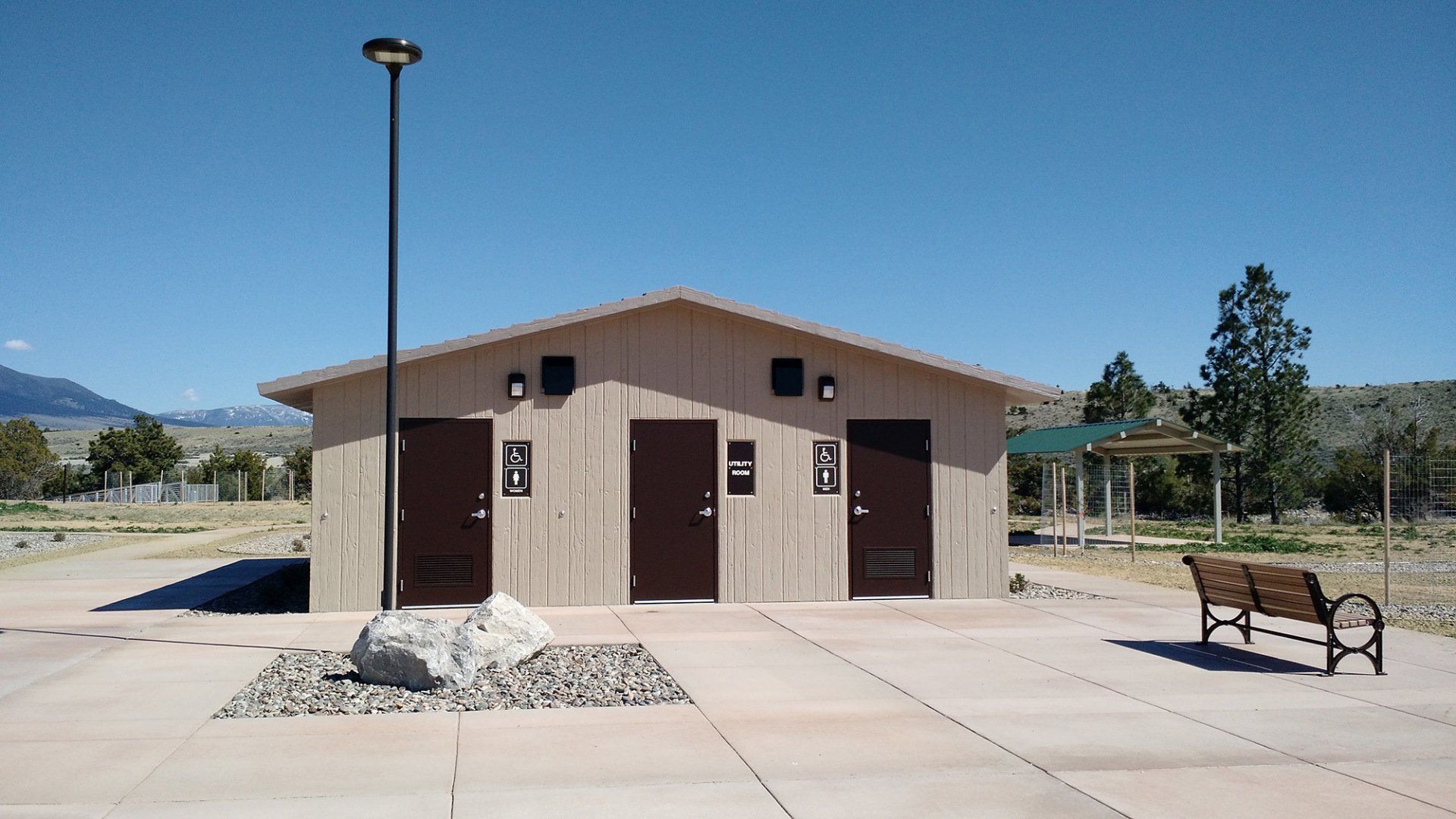 A small building with a bench in front of it