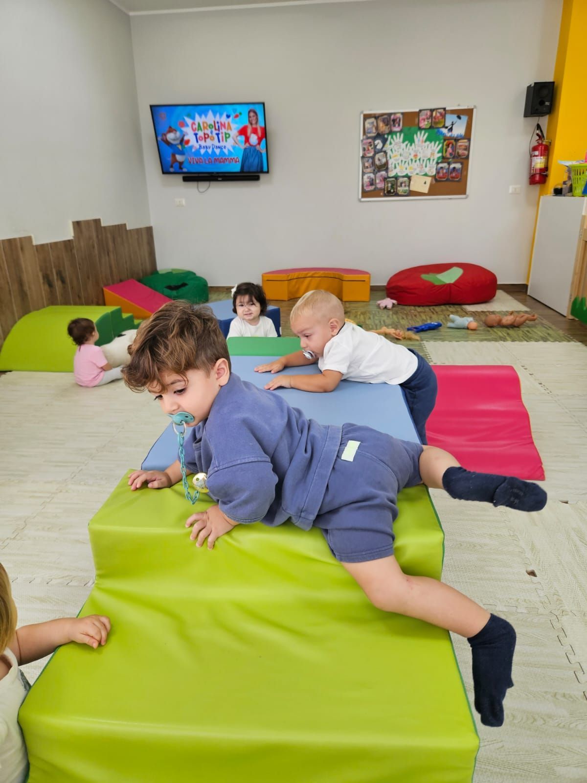Un gruppo di bambini sta giocando con dei blocchi di gommapiuma in una stanza.