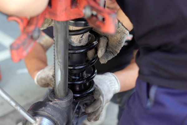Professional mechanic doing suspension repair — Valley City, ND — Quality Alignment & Brake Center