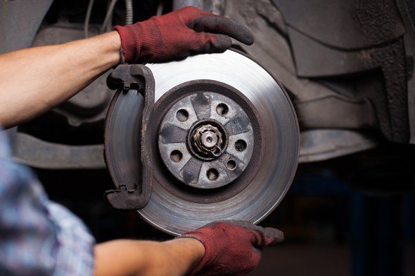 Mechanic doing brake repairs — Valley City, ND — Quality Alignment & Brake Center