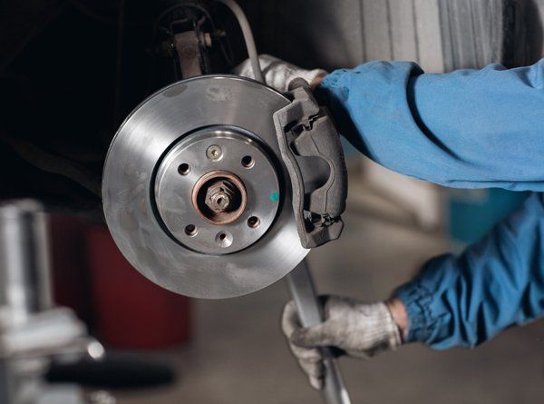 Professional mechanic doing brake repair — Valley City, ND — Quality Alignment & Brake Center
